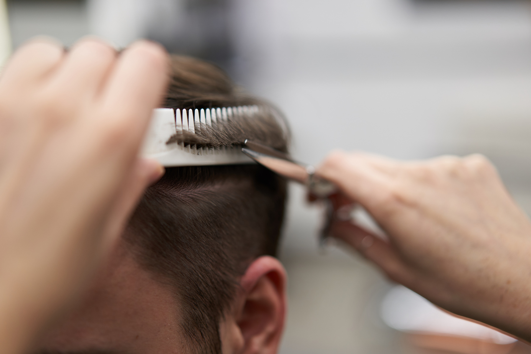 Hairdresser Cutting a Man's Hair